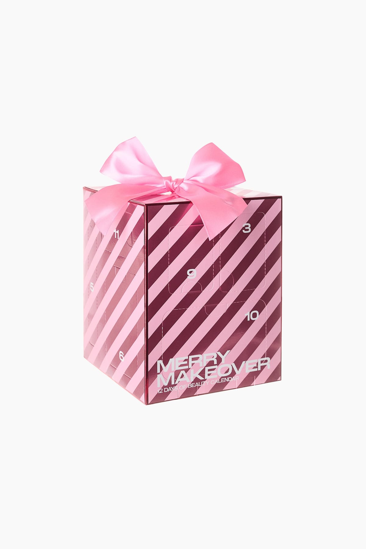 Kubusvormige H&M Merry Makeover adventskalender met roze en bordeauxrode strepen en een roze satijnen strik